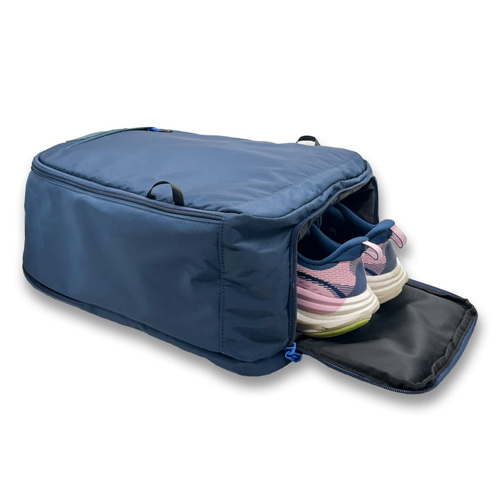 Abyssal Bolt Bag Backpack next to running shoes