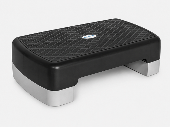 A black and gray rectangular Bedside Step Stool with a textured, non-slip surface and short legs, this versatile step platform is ideal for fitness exercises.