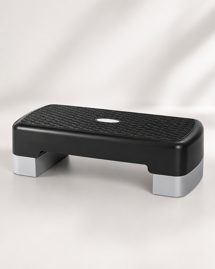 A black and gray Bedside Step Stool with a textured, non-slip surface is placed on a light background. This sturdy stool is ideal for fitness and exercise routines.