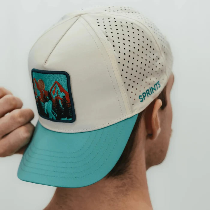 Runner wearing the Big Foot VP Hat in cream