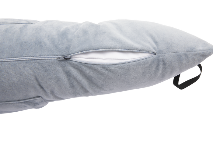 A close-up of the gray Chest Pillow shows a soft, plush texture, a black handle on the right, and a partially open zipper revealing its white inner lining—ideal as a supportive post-surgery pillow.