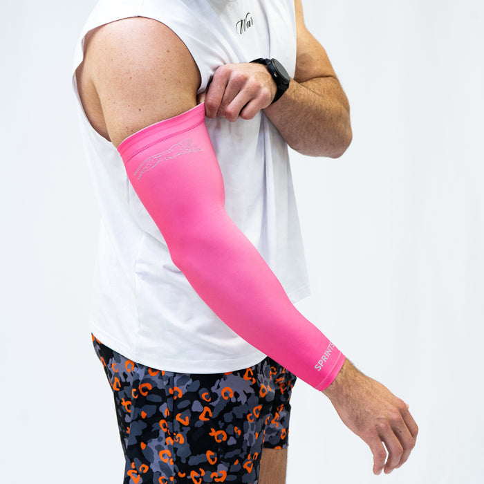 Person wearing the Compression Arm Sleeves in Neon Pink Flash Reflective