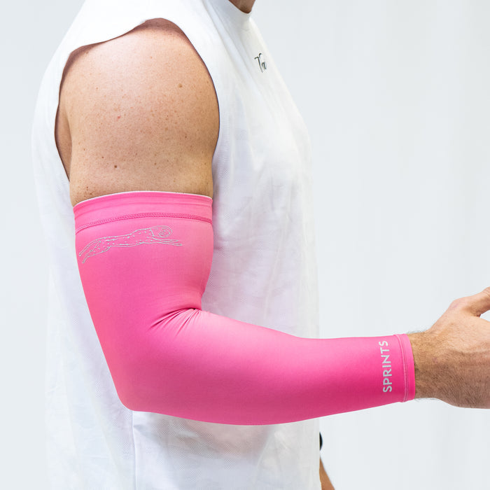 Person wearing the Compression Arm Sleeves in Neon Pink Flash Reflective, close-up