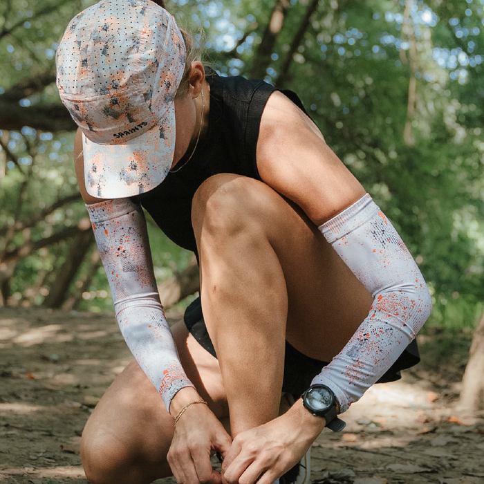 Close-up of the Compression Arm Sleeves in Setting Sun Evaporated Ventilation print