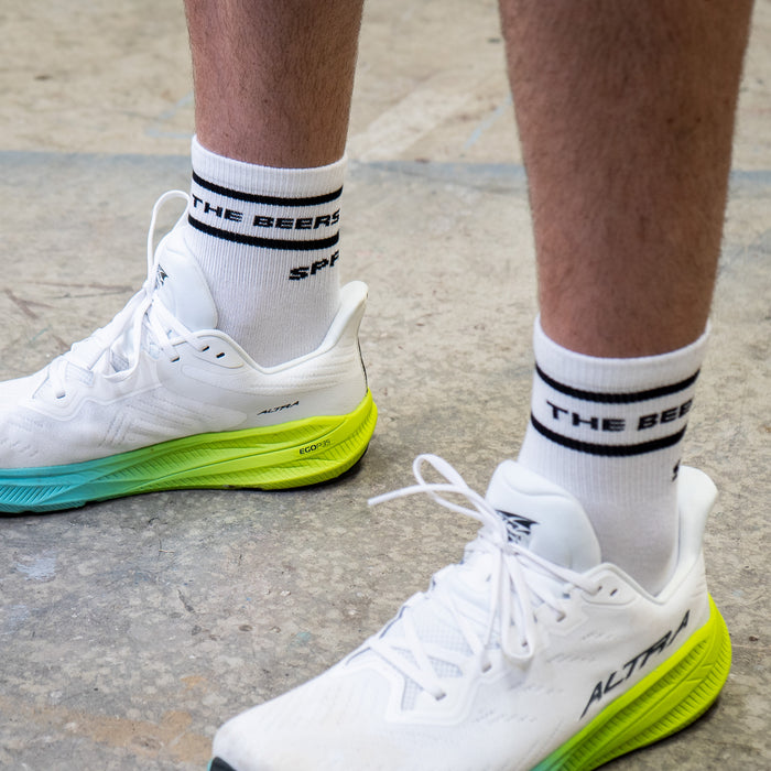 Person wearing the Core Zero Socks in Here for the Beers Run Club print