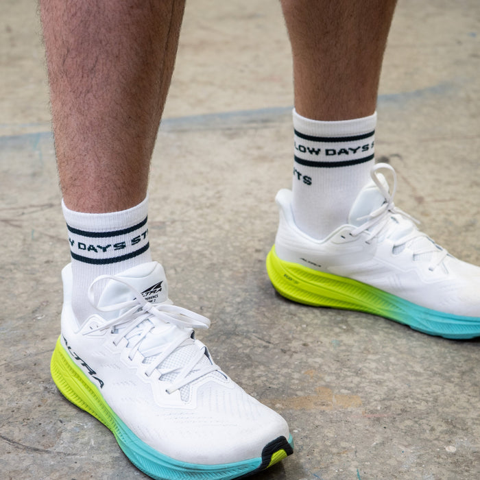 Person wearing the Core Zero Socks in Slow Days Still Count print