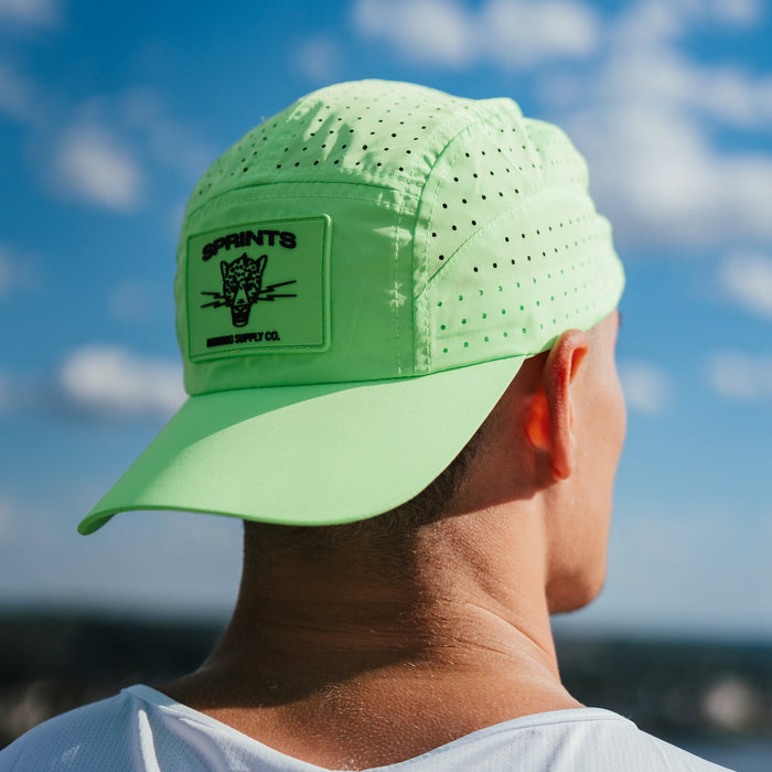 Runner wearing the Electric Lime HyperG Hat