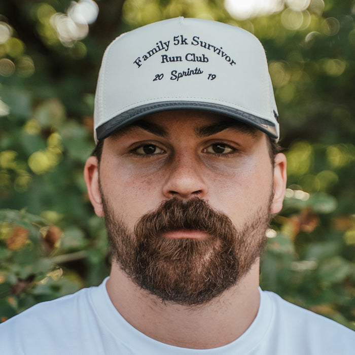 Person wearing the Family 5K Survivor Run Club Structured VP Hat at a Thanksgiving fun run
