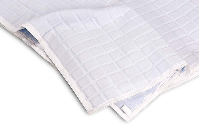 A close-up of the folded Final Sale: Opulence Glacier Blanket | Cooling & Weighted, featuring a subtle square pattern—perfect as a cooling, temperature-regulating weighted blanket for adults.