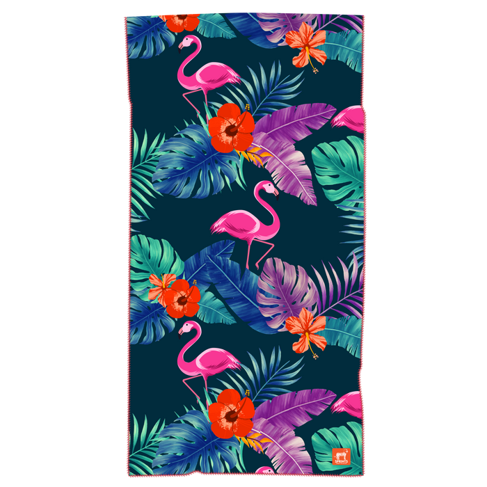 Towel with pattern of pink flamingos against tropical leaves in dark blue and green background