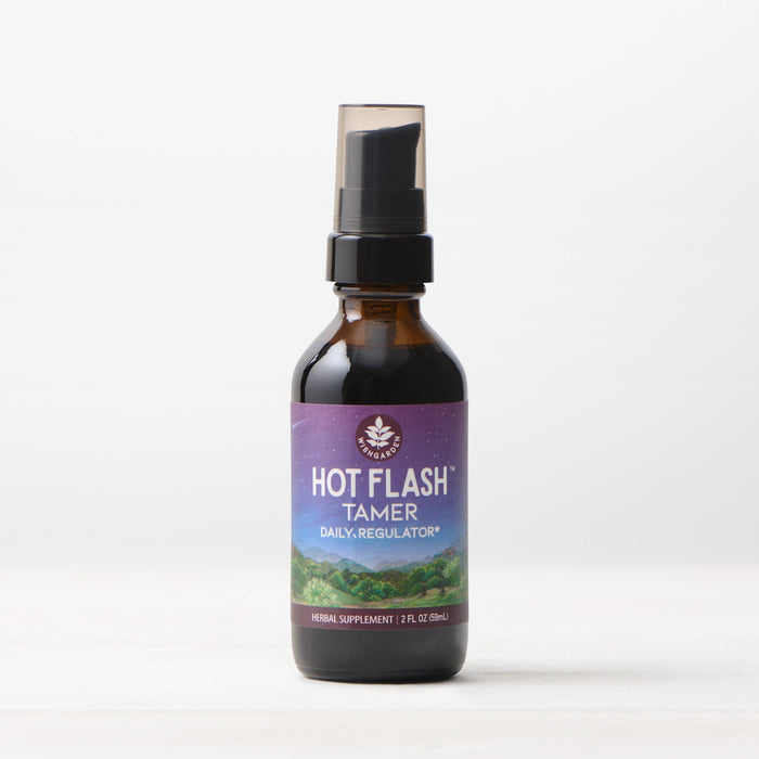 A small brown bottle with a black pump cap, labeled "Hot Flash Tamer, Daily Regulator," features a mountain landscape and purple accents. Shown on a plain white background, this herbal supplement supports natural menopause relief.
