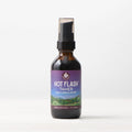 A small brown bottle with a black pump cap, labeled "Hot Flash Tamer, Daily Regulator," features a mountain landscape and purple accents. Shown on a plain white background, this herbal supplement supports natural menopause relief.