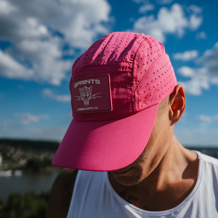 Runner wearing the Hot Pink Panic HyperG Hat in neon pink