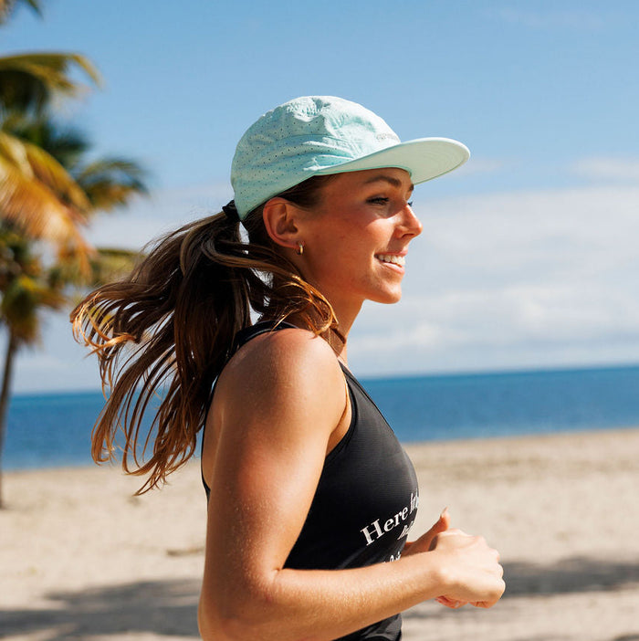 Runner wearing the Iced Out Blaz5 Flat Brim Hat outdoors