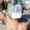 Runner wearing the Iced Out M6SH Hat with full mesh crown in a downtown setting