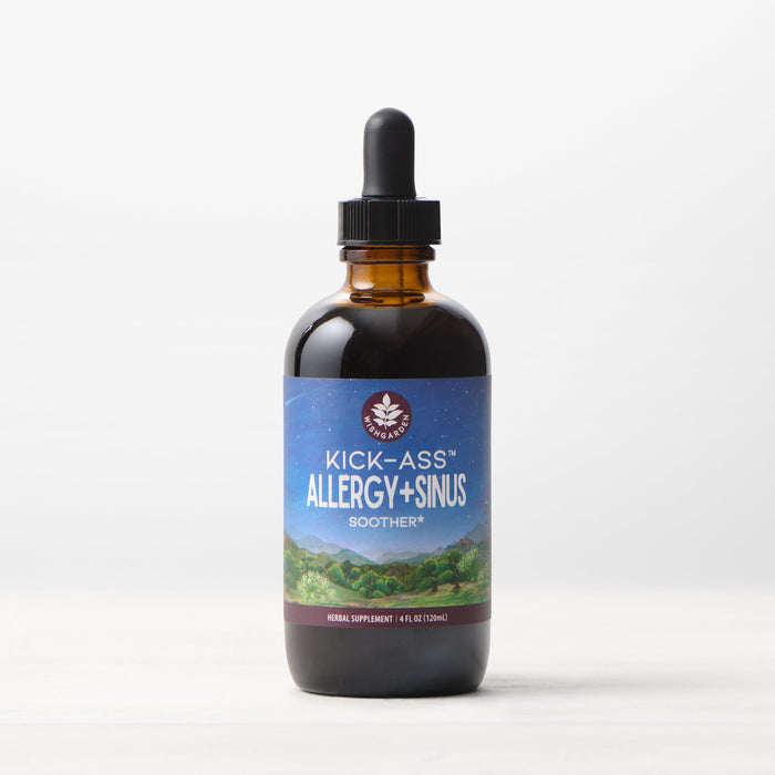 An amber glass dropper bottle labeled Kick-Ass Allergy & Sinus, Soother rests on a white surface. Its label shows mountains beneath a night sky. This 4 fl oz (120 ml) herbal supplement provides non-drowsy allergy and sinus support.