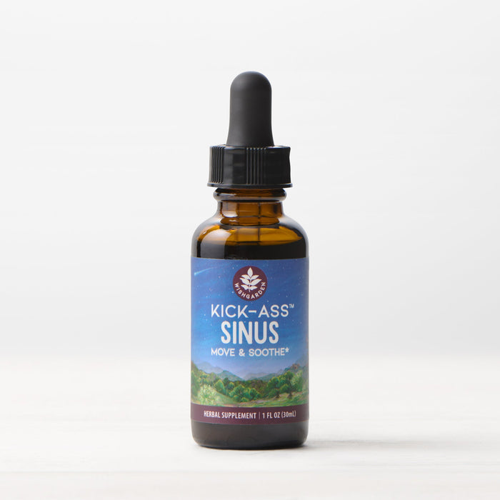 A 1 fl oz (30 ml) amber glass dropper bottle of Kick-Ass Sinus, Move & Soothe herbal supplement rests on a light surface with a white background—an herbal remedy for upper respiratory support.