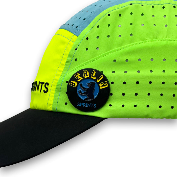 Laufen Berlin Enamel Pin attached to a hat brim