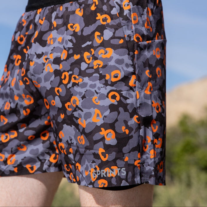 Man wearing the Avigate 5 inch Fusion Short in Jag Camo Blaze, running