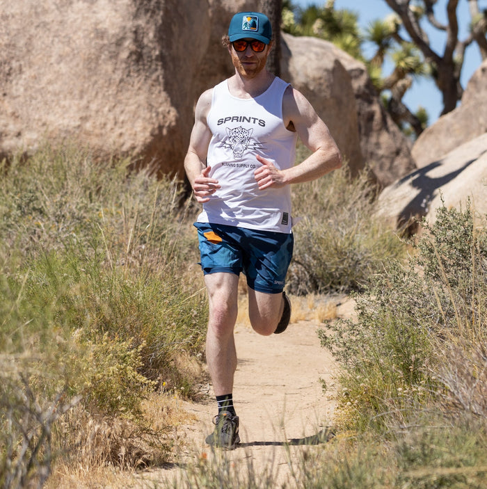 Man wearing the Avigate 5 inch Fusion Short in Sasquatch print, running