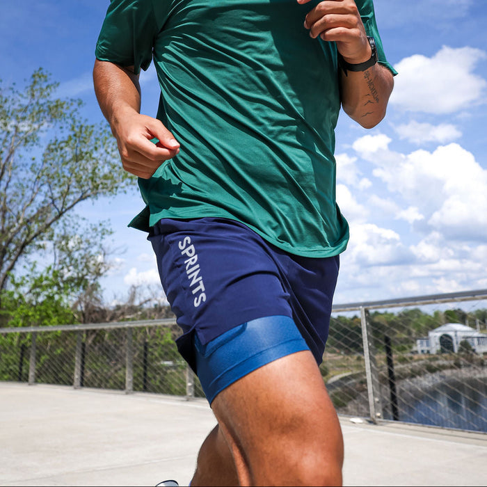 Man wearing the Avigate 5 inch Fusion Short in Stealth Navy, side view