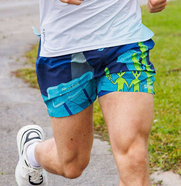 Man wearing the Avigate 5 inch Fusion Short in Uninvited Alien Antics print