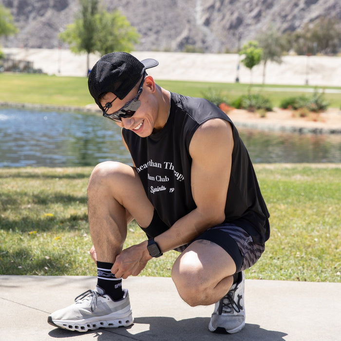 Man wearing the Core Zero Framework Tank in Cheaper Than Therapy print, side view