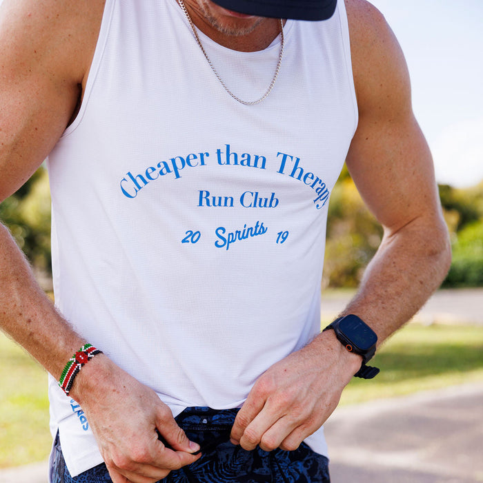 Man wearing the Core Zero Running Tank in Cheaper Than Therapy Run Club White
