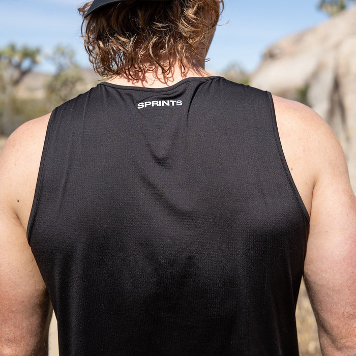 Man wearing the Core Zero Running Tank in Stealth Black, running