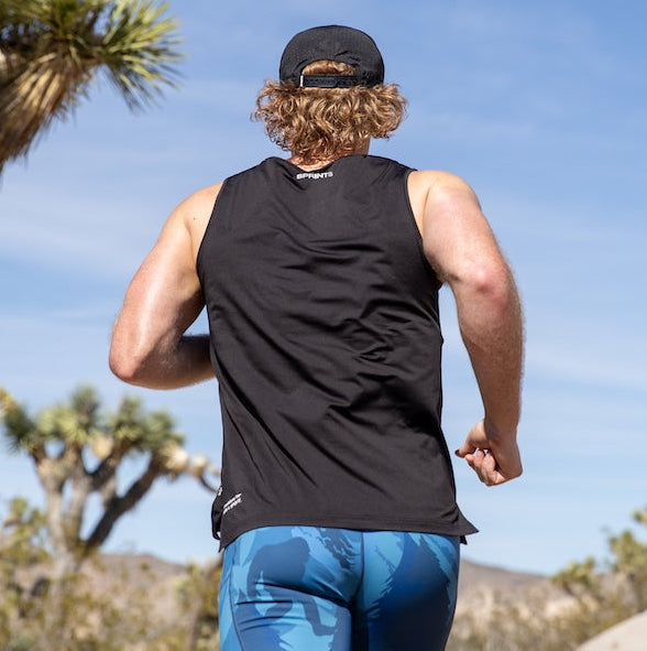 Man wearing the Core Zero Running Tank in Stealth Black, close-up