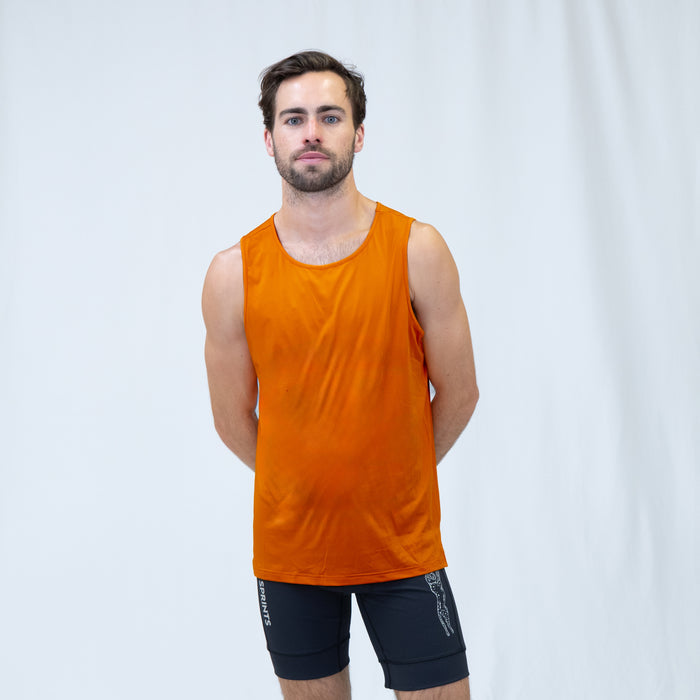 Man wearing the Core Zero Running Tank in Vault Jag Orange, close-up