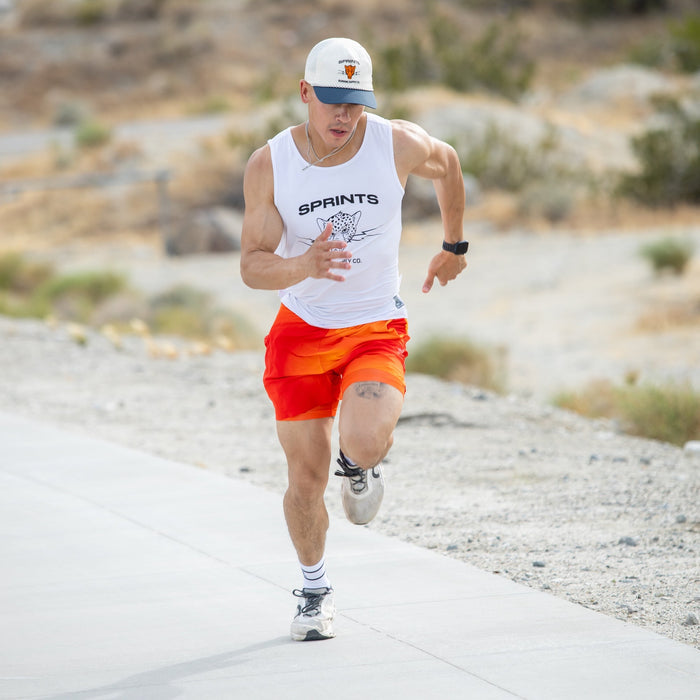 Man wearing the Core Zero Running Tank in Vault Jag White, side view