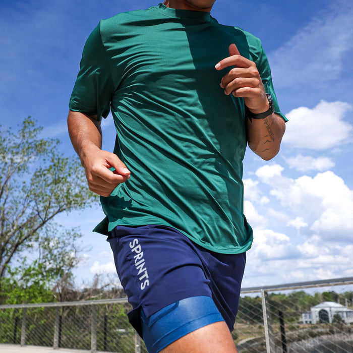 Man wearing the Core Zero Tech Tee in Miles Worldwide print, side view