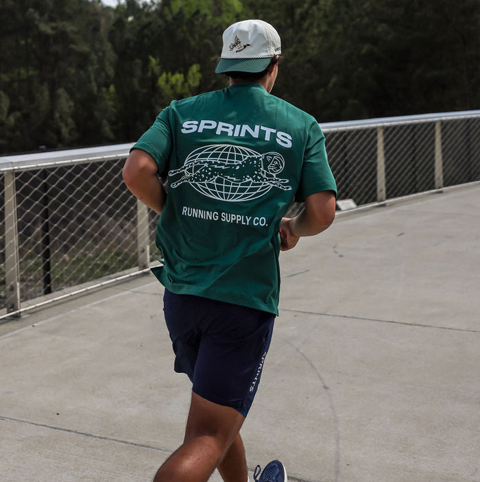 Man wearing the Core Zero Tech Tee in Miles Worldwide print, close-up
