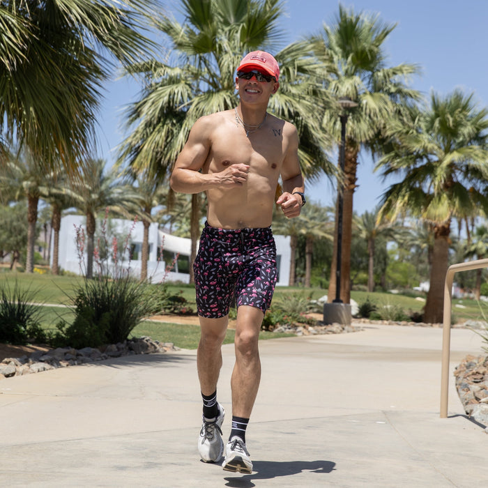 Man wearing the Flexion 8 inch Half Tights in Find the Fauxmingo Black, running