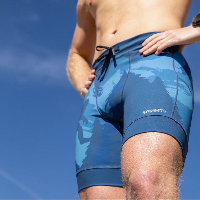 Man wearing the Flexion 8 inch Half Tights in Sasquatch Habitat print