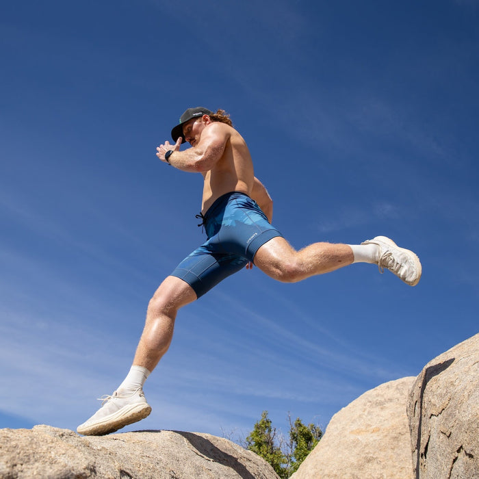 Man wearing the Flexion 8 inch Half Tights in Sasquatch Habitat print, running