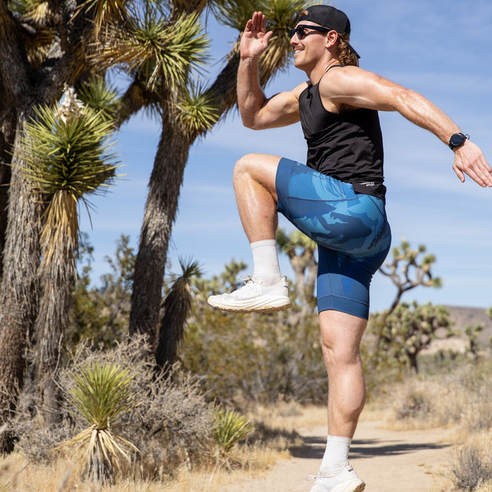 Man wearing the Flexion 8 inch Half Tights in Sasquatch Habitat print, close-up
