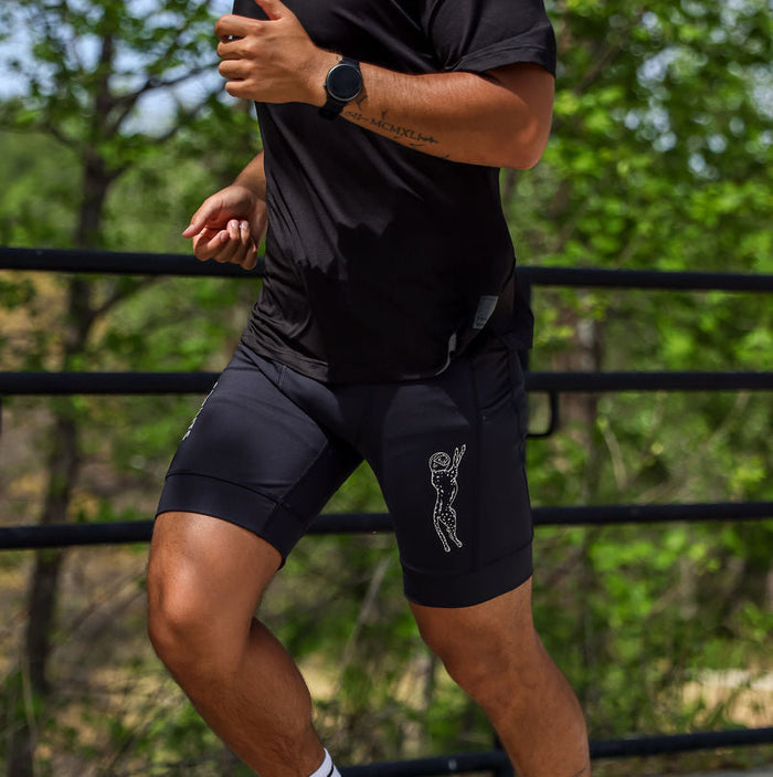 Man wearing the Flexion 8 inch Half Tights in Stealth Black, side view