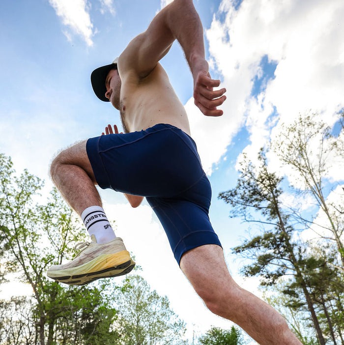 Man wearing the Flexion 8 inch Half Tights in Stealth Navy, side view