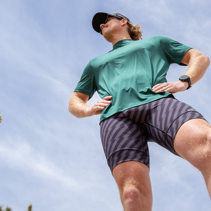 Man wearing the Flexion 8 inch Half Tights in Velocity Blitz Black, running