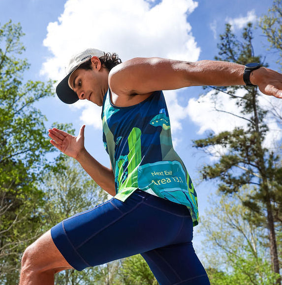Man wearing the Uninvited Alien Antics Running Tank, side view