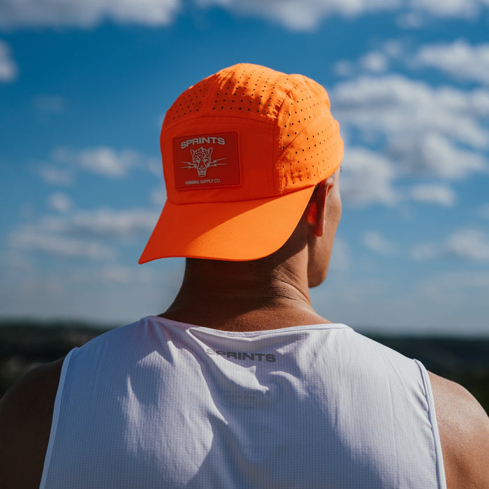 Runner wearing the Out of Breath Orange HyperG Hat