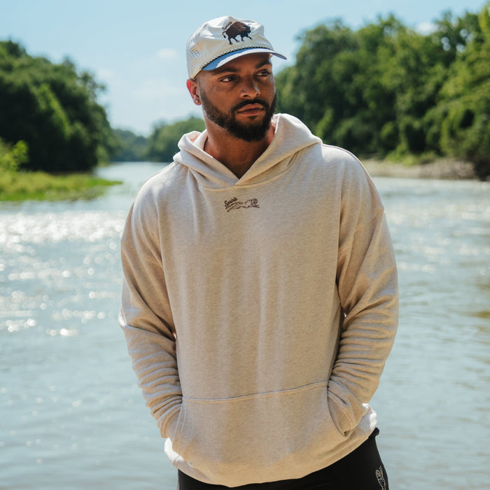 Person wearing the Oversized Hoodie in Plainsman print, close-up
