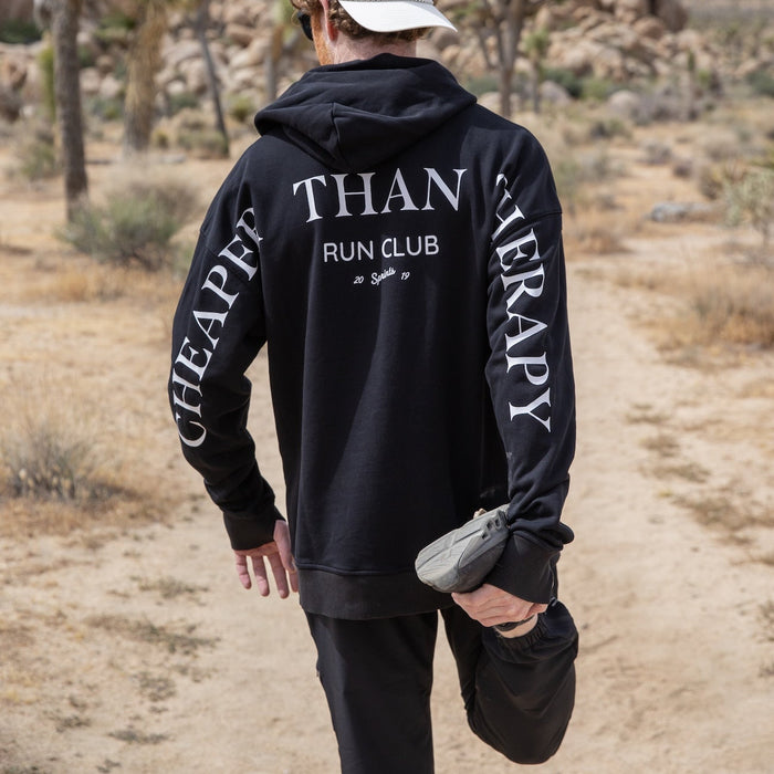 Person wearing the Run Club Oversized Hoodie in Cheaper than Therapy Black, close-up