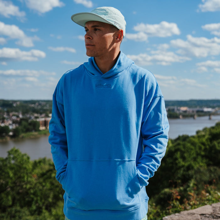 Person wearing the Run Club Oversized Hoodie in Cheaper than Therapy Blue