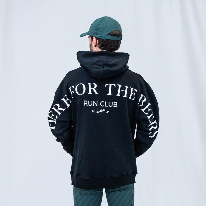 Person wearing the Run Club Oversized Hoodie in Here for the Beers Black