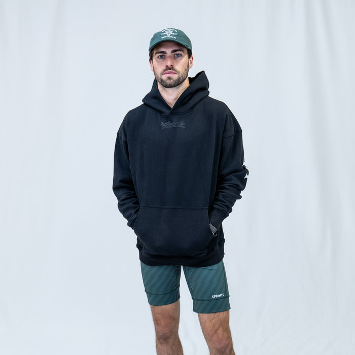 Person wearing the Run Club Oversized Hoodie in Here for the Beers Black, close-up
