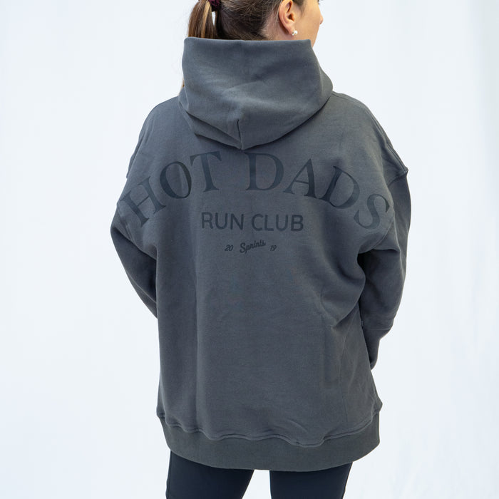 Person wearing the Run Club Oversized Hoodie in Hot Dads Gray, close-up