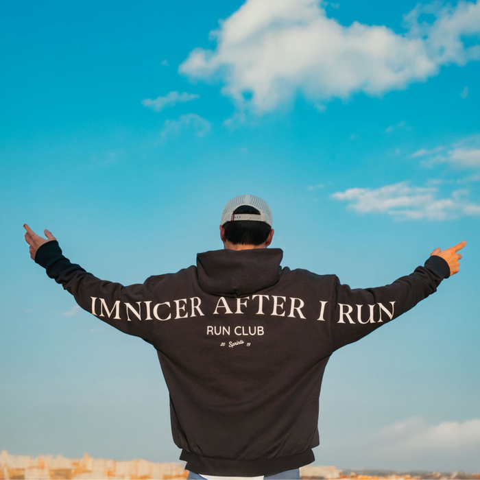 Person wearing the Run Club Oversized Hoodie in I'm Nicer After I Run Navy